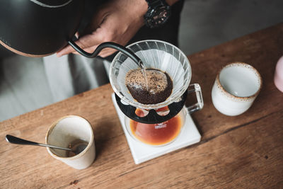 Midsection of coffee cup on table