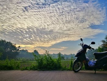 Bicycle on road against sky
