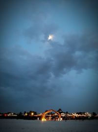 Illuminated buildings against sky at night