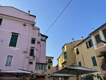 Low angle view of residential buildings against blue sky