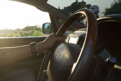 Midsection of man driving car