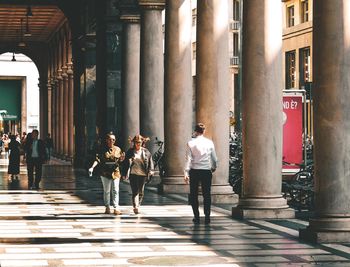 People walking in corridor of building