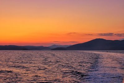 Scenic view of sea against orange sky