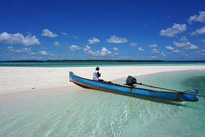 Boat in calm blue sea against the sky