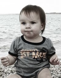 Portrait of cute boy standing at beach