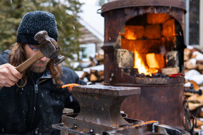 View of blacksmith working outdoors
