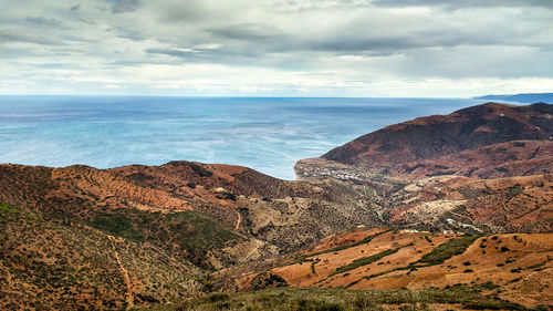 Scenic view of sea and mountains against sky