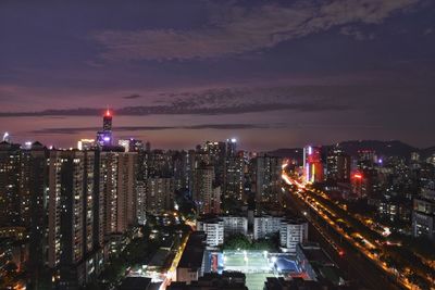 High angle view of illuminated city buildings at night