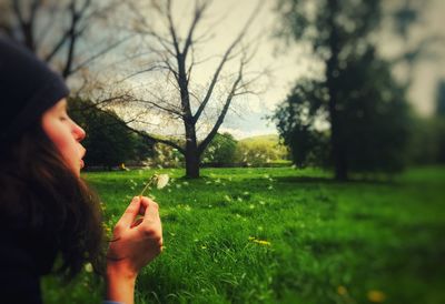 Side view of woman hand on field