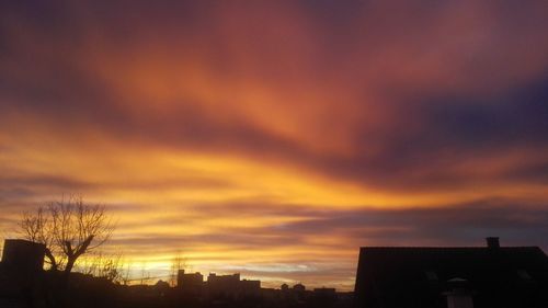 Silhouette of building against cloudy sky