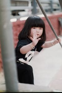 Portrait of cute girl gesturing outdoors