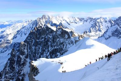 People skiing on snow covered mountain