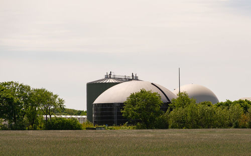 Built structure on field against sky