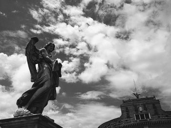 Low angle view of statue against cloudy sky