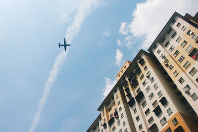 Low angle view of airplane flying against sky