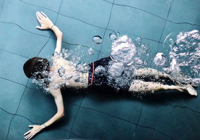 Full length of boy swimming in pool