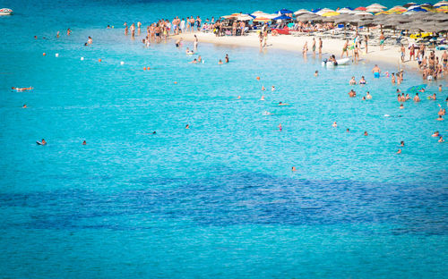 High angle view of people swimming in sea