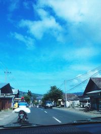 Cars on road against sky