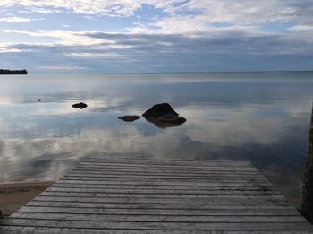 Pier over lake against sky