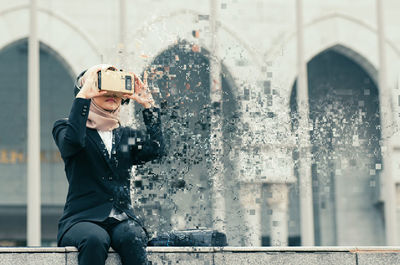 Young businesswoman using virtual reality simulator