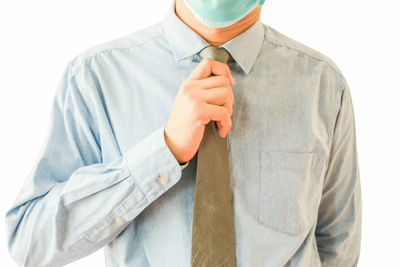 Midsection of man wearing mask against white background