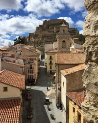 High angle view of buildings in town against sky