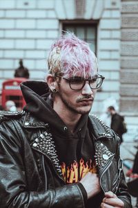 Portrait of young man looking away outdoors