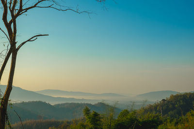 Scenic view of mountains against clear sky at sunset