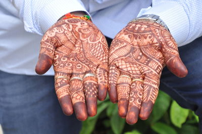 Midsection of woman showing henna tattoo