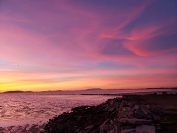 Scenic view of beach against sky during sunset