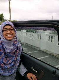 Portrait of smiling woman in car