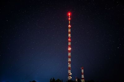 Low angle view of illuminated building against sky at night