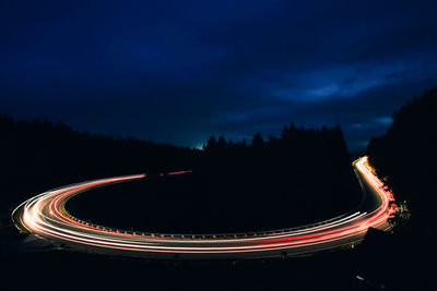 High angle view of light trails on road at night