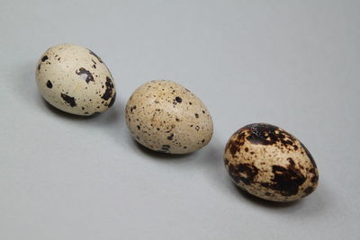 Close-up of different eggs against white background