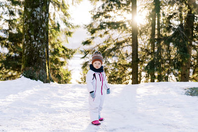 Full length of woman skiing on snow covered field