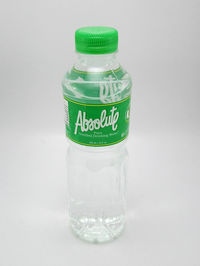 Close-up of glass bottle against white background