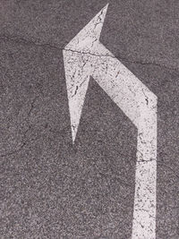 High angle view of arrow symbol on road