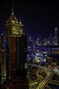 Illuminated cityscape against sky at night