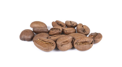 Close-up of coffee beans against white background