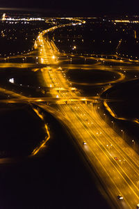 High angle view of illuminated road in city at night