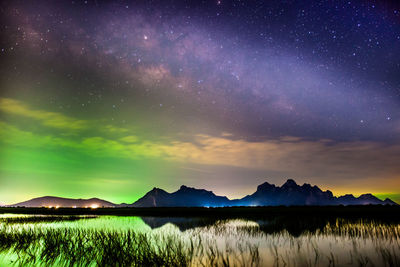 Scenic view of lake against sky at night