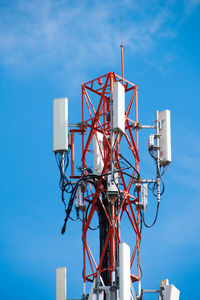 Low angle view of communications tower against blue sky