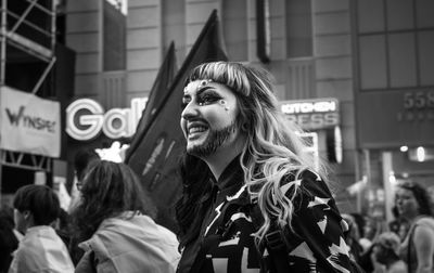 Portrait of woman standing on street in city