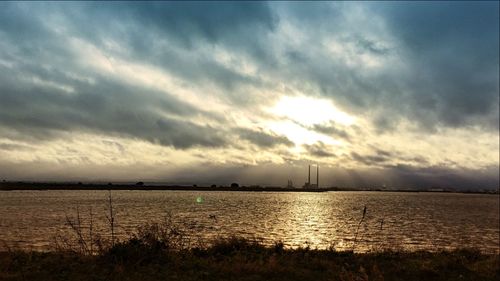 Scenic view of landscape against cloudy sky