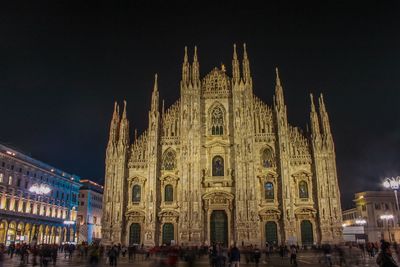 Group of people in front of building at night