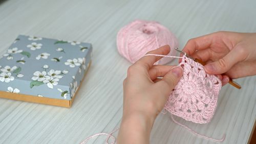 Cropped hand of woman holding jigsaw