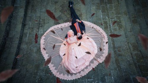 High angle view of bridegroom lying on ground outdoors