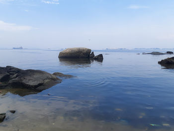 Rocks in sea against sky