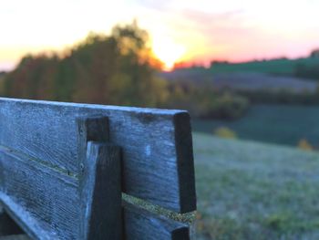 Close-up of stone wall against sky during sunset