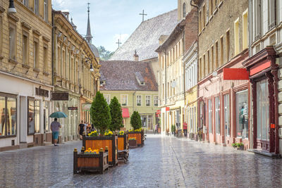 Street amidst buildings in city against sky